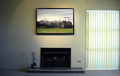 The original, 'Tractor with Mountain' by Grant McSherry is a large size oil painting, finished in a hand crafted, black lacquer shadow frame with negative space.